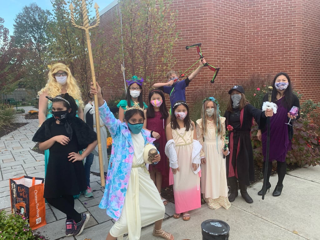 Book club in costume wearing masks in the Reading Garden